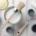 Paint brush, sponge roller, paints, waxes and other painting or decorating supplies on white wooden planks